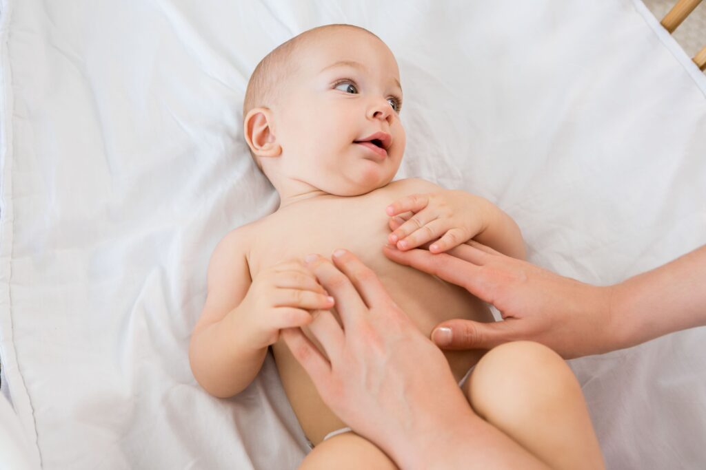 hands-mother-playing-with-baby-boy-cradle-1