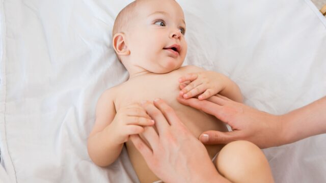 hands-mother-playing-with-baby-boy-cradle-1